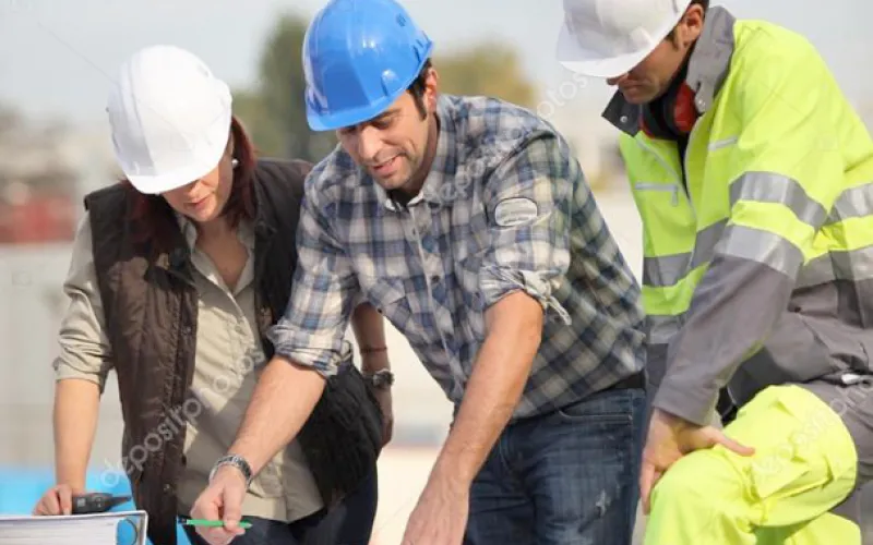 construction workers looking at blueprints